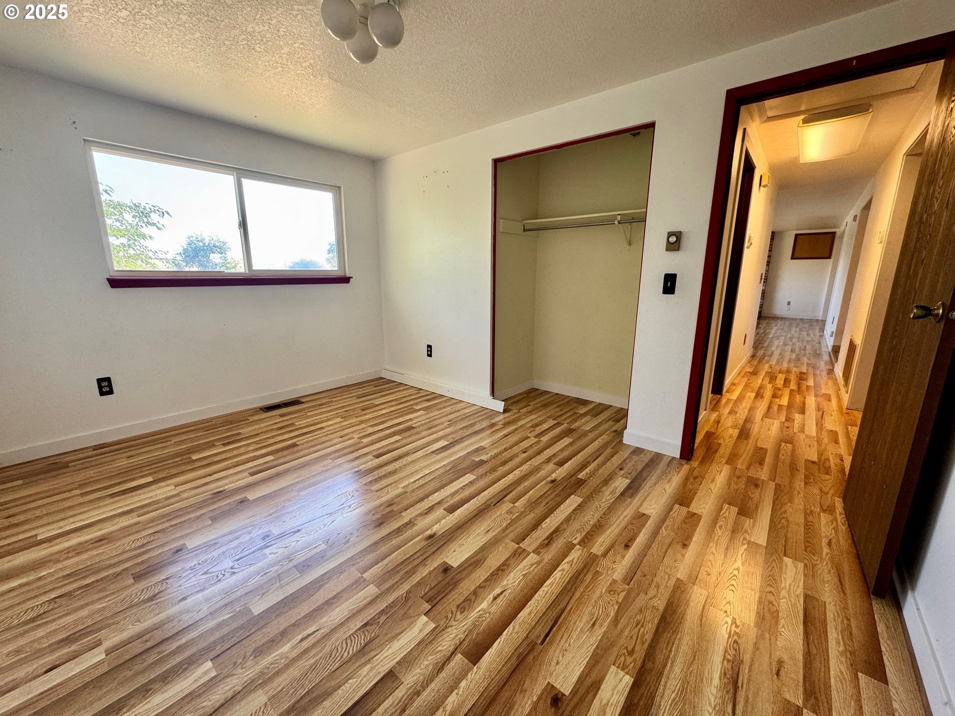 1275 West 1st Street Arlington, OR 97812 - Photo 19 of 24 a view of a room with wooden floor and white walls