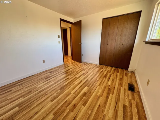 a view of a room with wooden walls and window