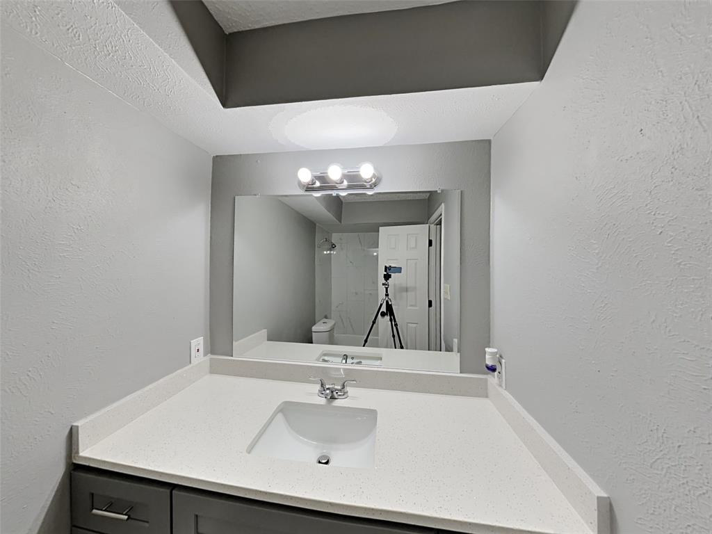 702 Redbud Drive Forney, TX 75126 - Photo 15 of 16 a bathroom with a sink and a mirror