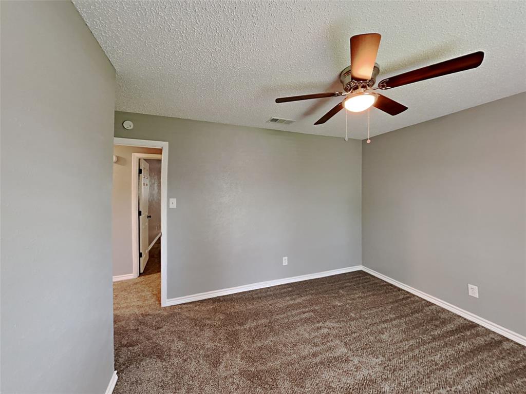 702 Redbud Drive Forney, TX 75126 - Photo 4 of 16 a view of an empty room with a chandelier fan