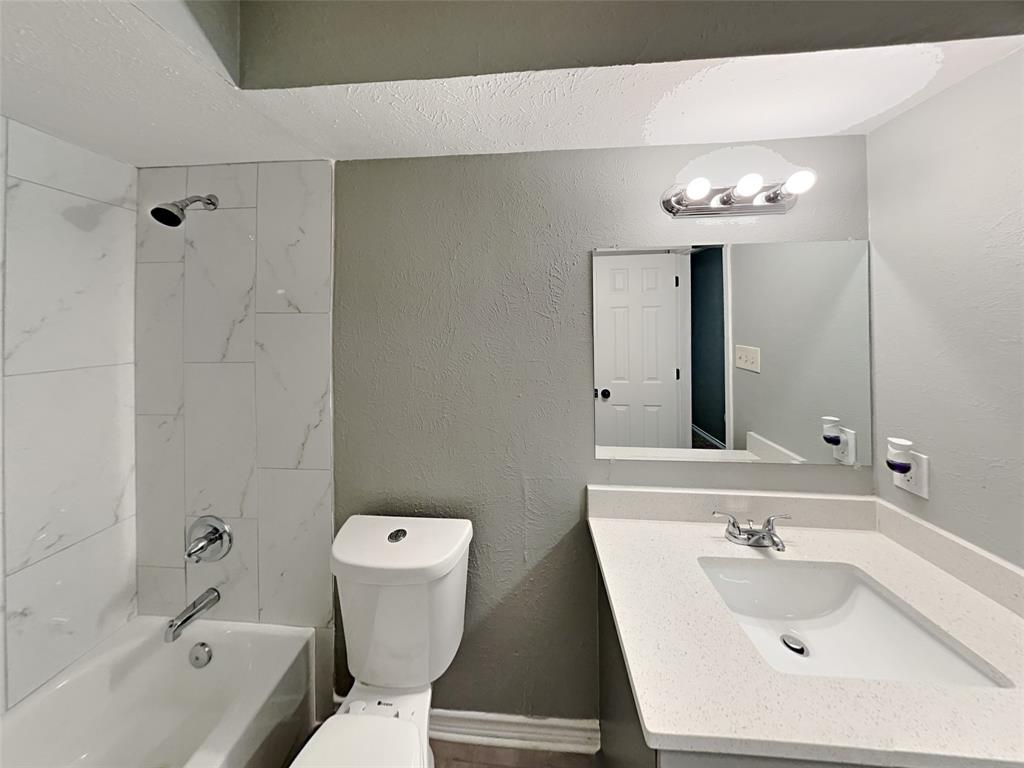 702 Redbud Drive Forney, TX 75126 - Photo 6 of 16 a bathroom with a sink a toilet and shower