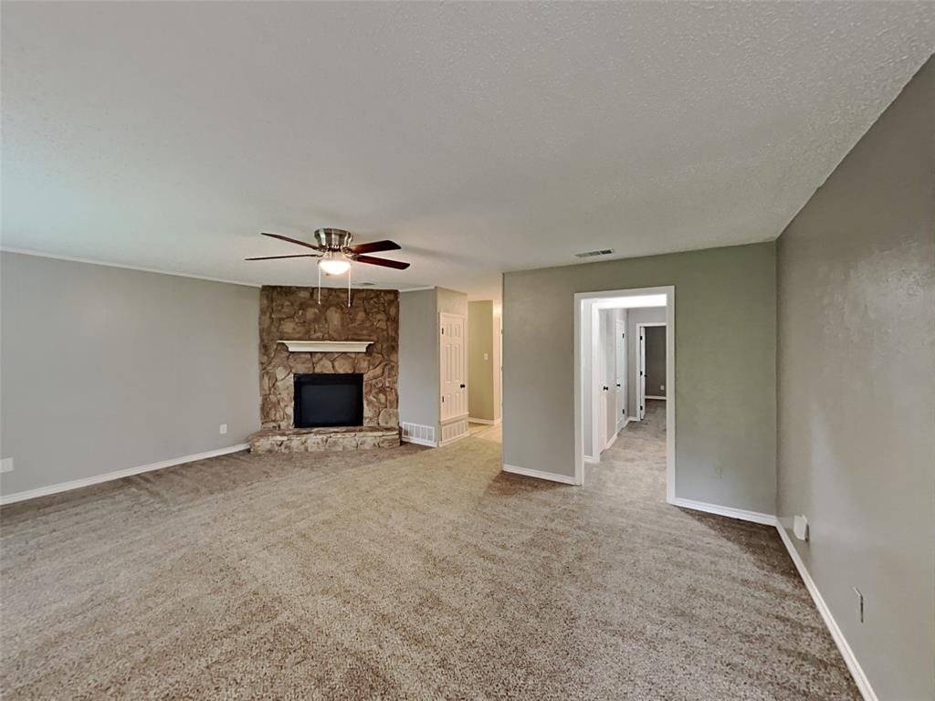 702 Redbud Drive Forney, TX 75126 - Photo 8 of 16 an empty room with windows and fireplace