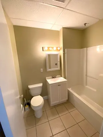 a bathroom with a toilet a sink and bathtub