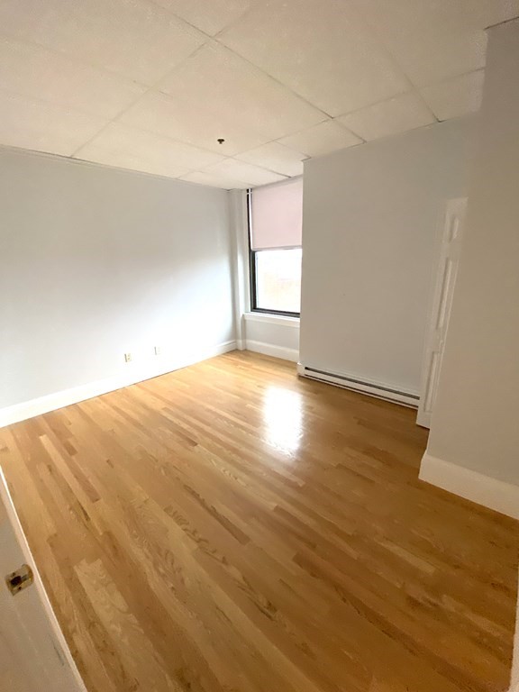 11 Lawrence Street, Unit 606 Lawrence, MA 01840 - Photo 10 of 10 a view of empty room with wooden floor and fan
