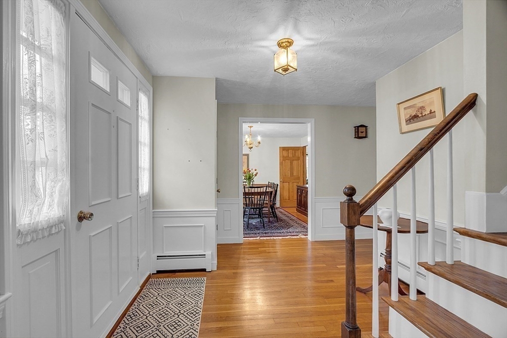 1 Chester Road Boxborough, MA 01719 - Photo 14 of 41 a view of a livingroom with wooden floor and stairs