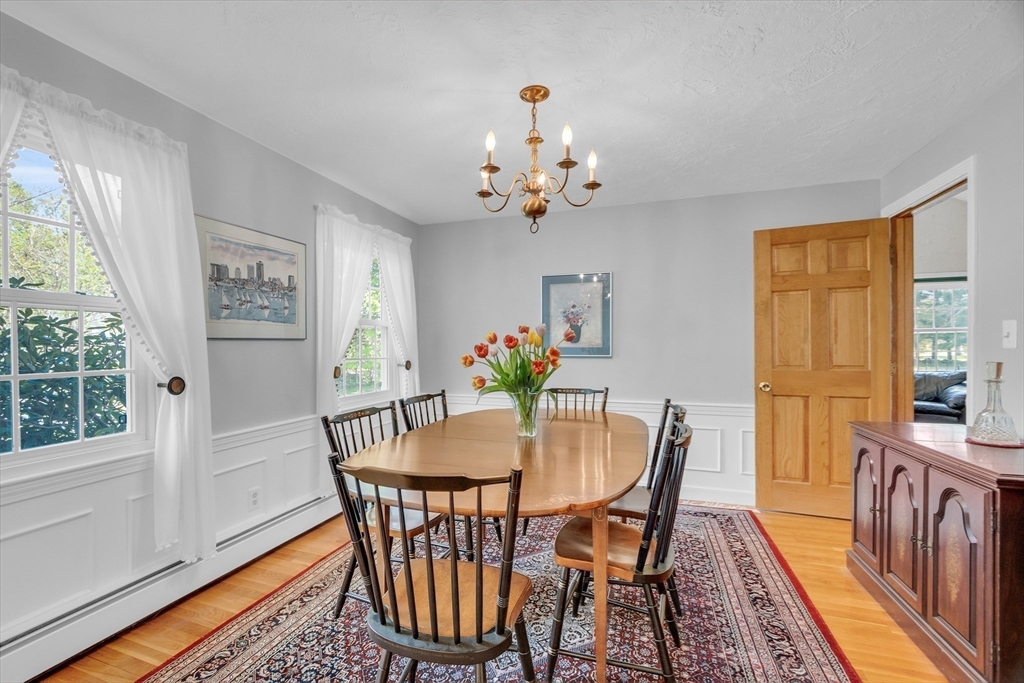 1 Chester Road Boxborough, MA 01719 - Photo 28 of 41 a view of a dining room with furniture a chandelier and wooden floor