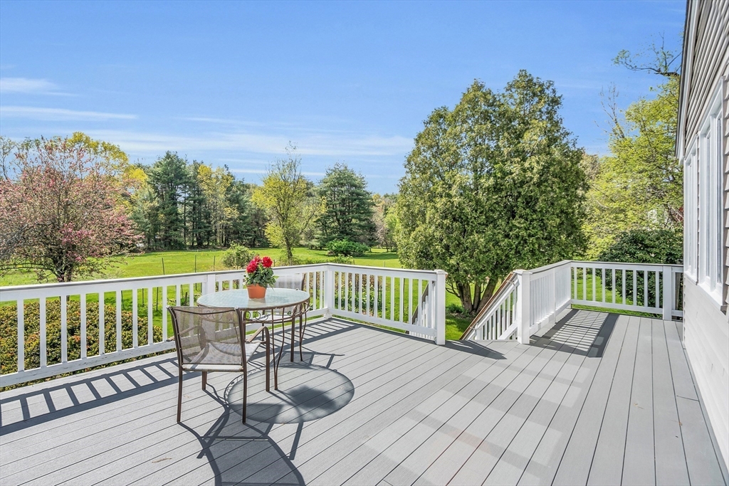 1 Chester Road Boxborough, MA 01719 - Photo 6 of 41 a view of deck with furniture and trees in the background