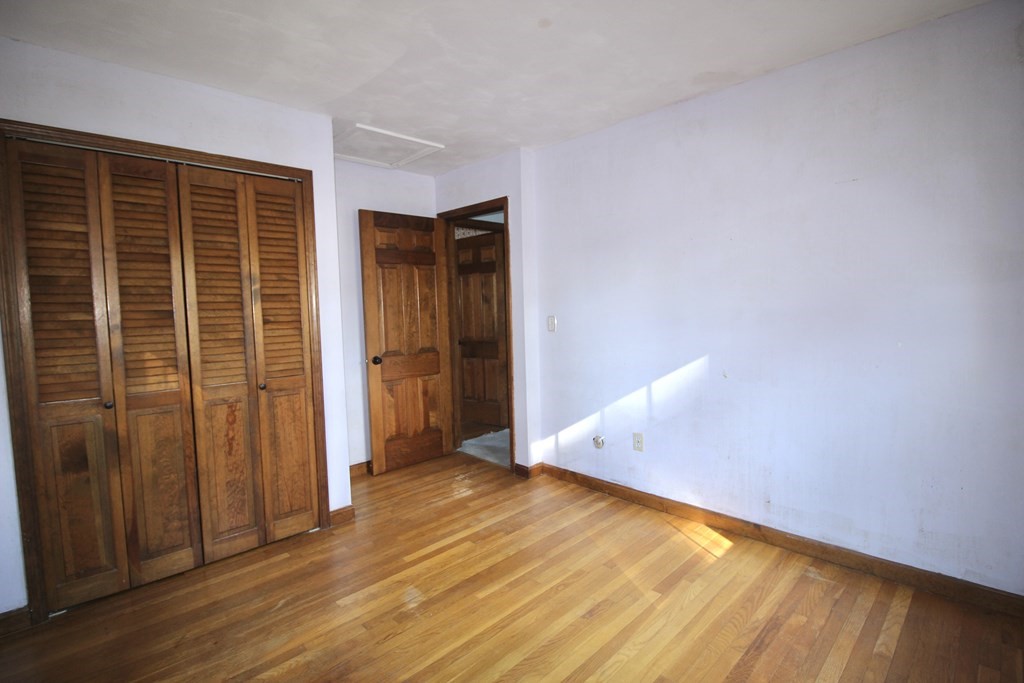 111 County Road East Freetown, MA 02717 - Photo 25 of 29 an empty room with wooden floor and door