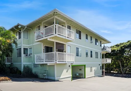 a view of a house with a small yard and plants
