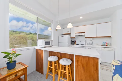 a kitchen with a table chairs sink and cabinets
