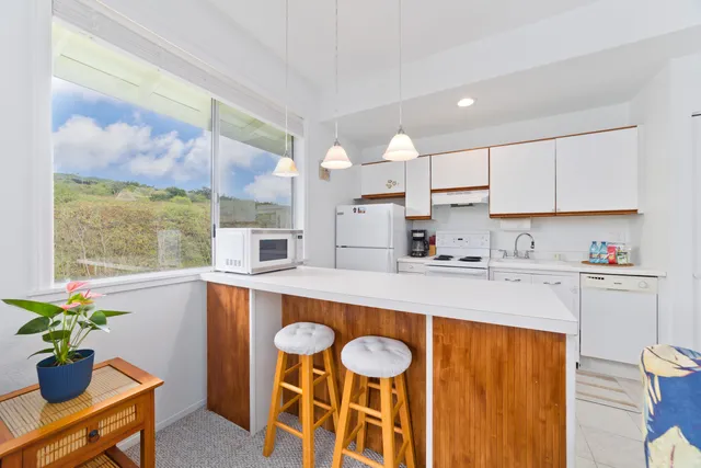 a kitchen with a table chairs sink and cabinets