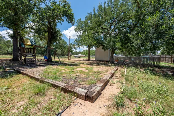 a view of a backyard with swimming pool