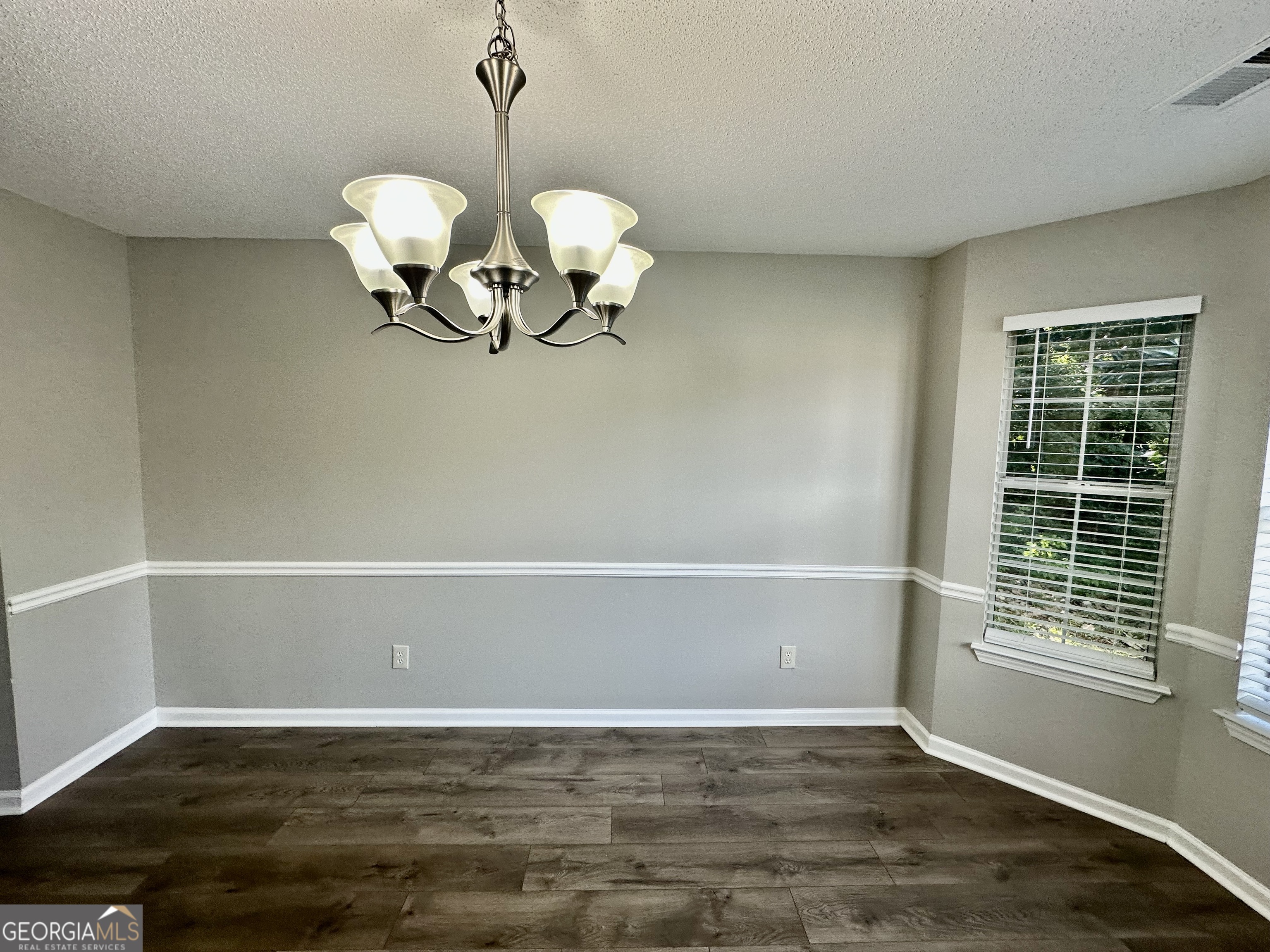 3763 Waldrop Hills Drive Decatur, GA 30034 - Photo 12 of 31 a view of an empty room with wooden floor and a window