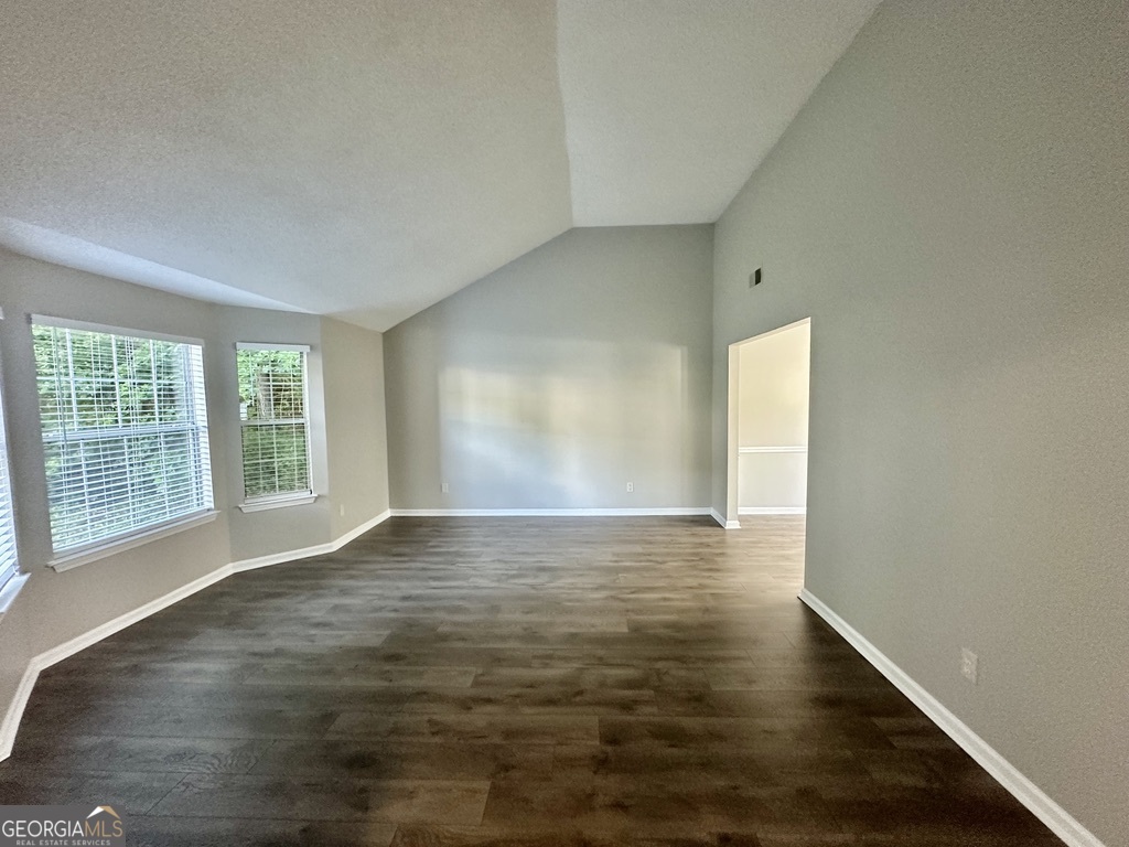 3763 Waldrop Hills Drive Decatur, GA 30034 - Photo 5 of 31 a view of an empty room with wooden floor and a window