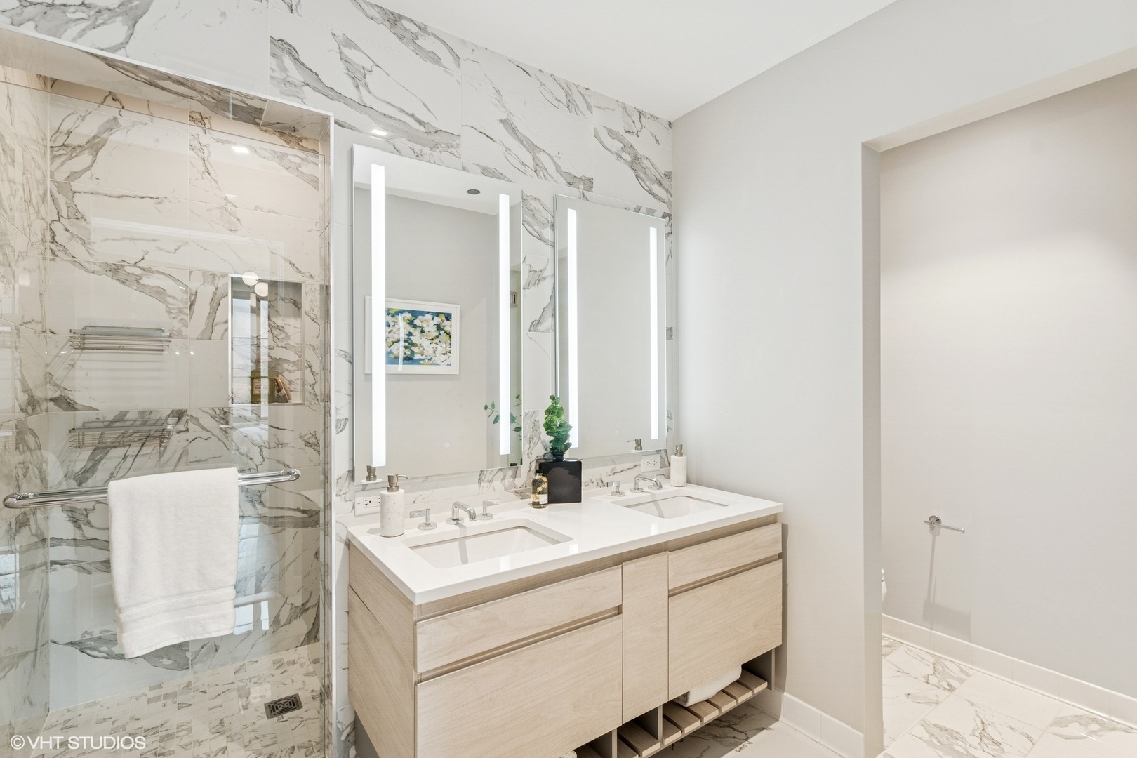 1400 West Monroe Street, Unit 4F Chicago, IL 60607 - Photo 14 of 22 a bathroom with a sink mirror and a shower