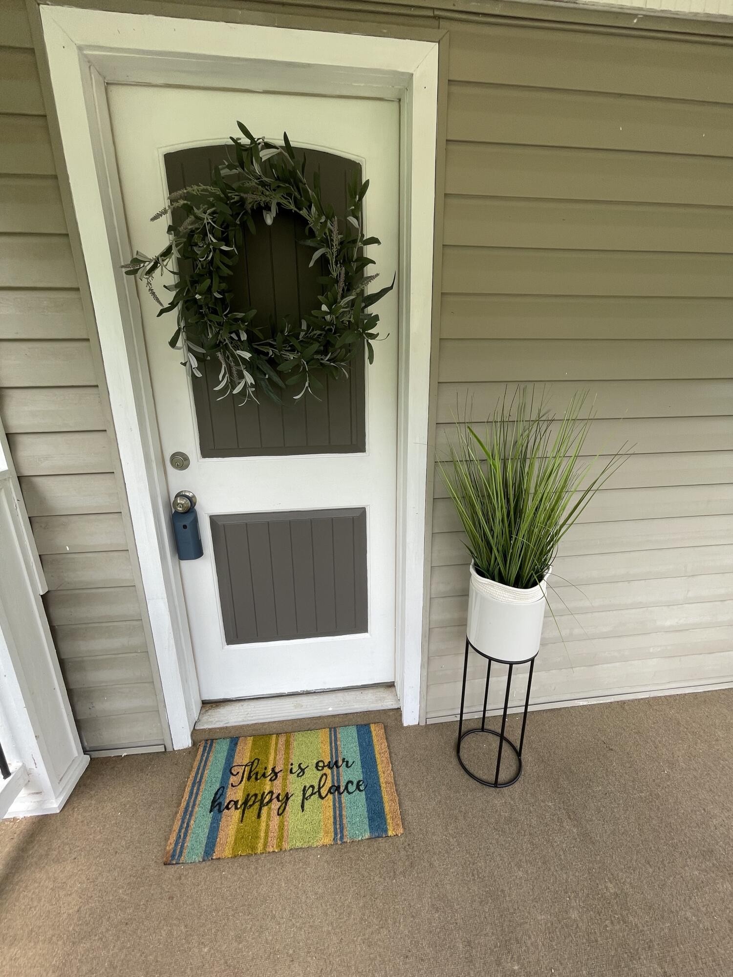 474 Pumpkin Hollow Road Heiskell, TN 37754 - Photo 3 of 22 a white house with a potted plant on a table and chairs