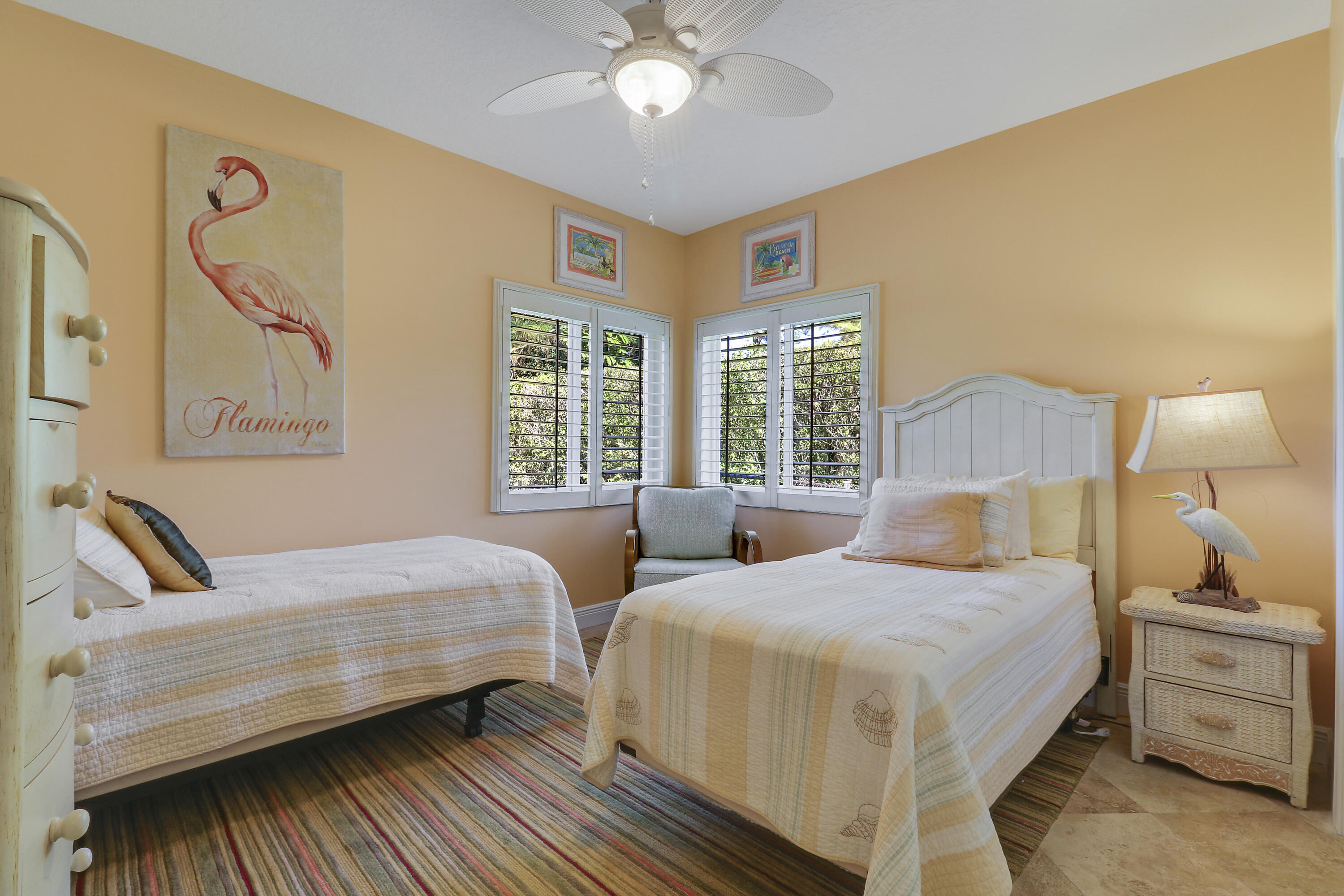 5213 Desert Vixen Road Palm Beach Gardens, FL 33418 - Photo 22 of 28 a bedroom with two beds and a chandelier
