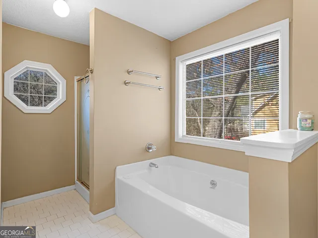 a bathroom with a bathtub and a window