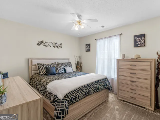 a bedroom with a bed and a dresser