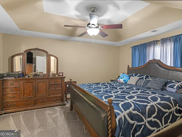 a bedroom with a bed and a dresser