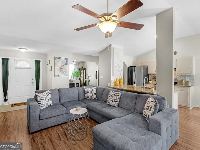 a living room with furniture and a chandelier