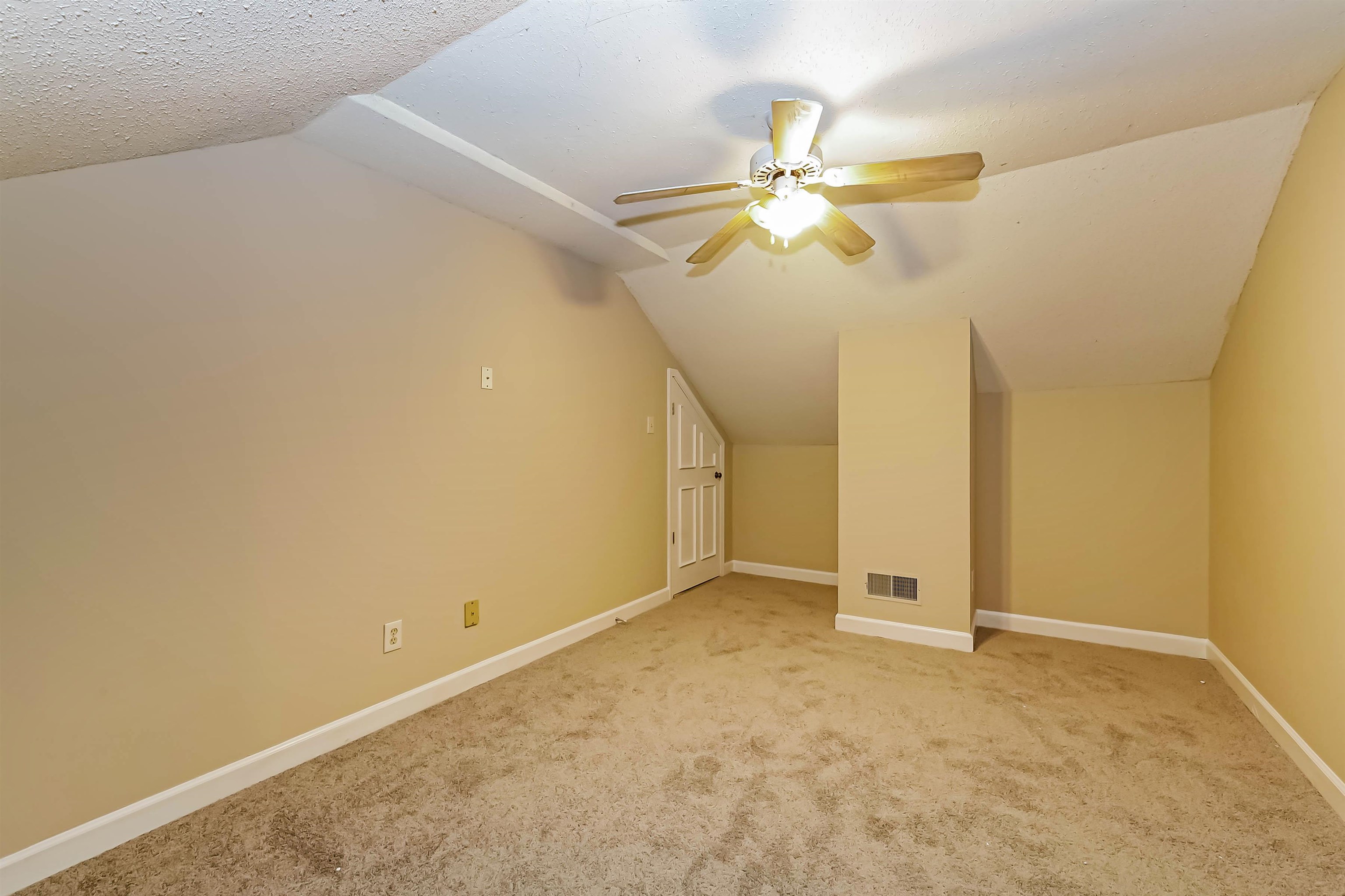 432 Leaf Trail Lane Memphis, TN 38018 - Photo 13 of 17 Additional living space with lofted ceiling, light carpet, a textured ceiling, and ceiling fan