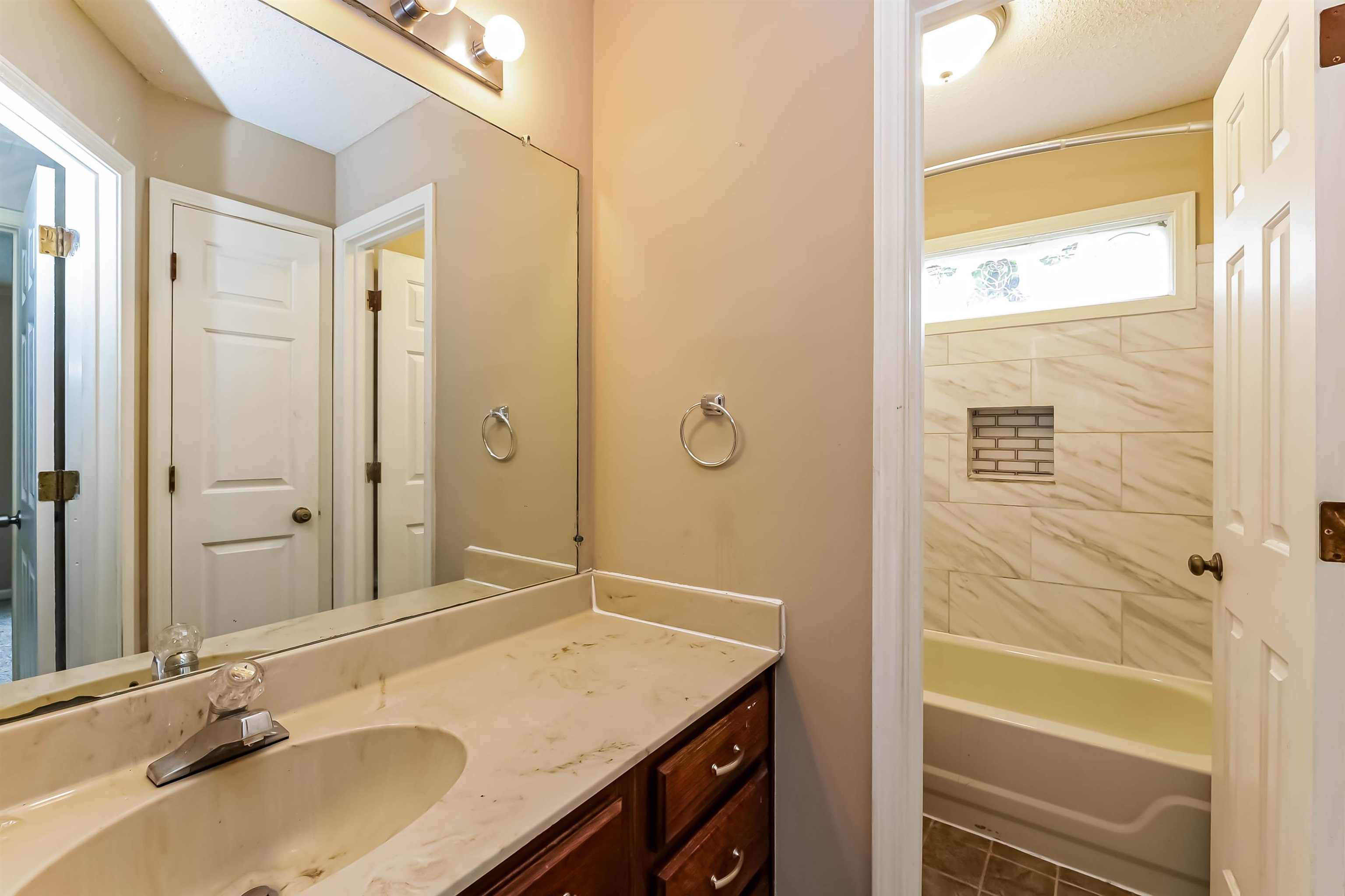 432 Leaf Trail Lane Memphis, TN 38018 - Photo 15 of 17 Bathroom featuring tile patterned floors, tiled shower / bath combo, and vanity