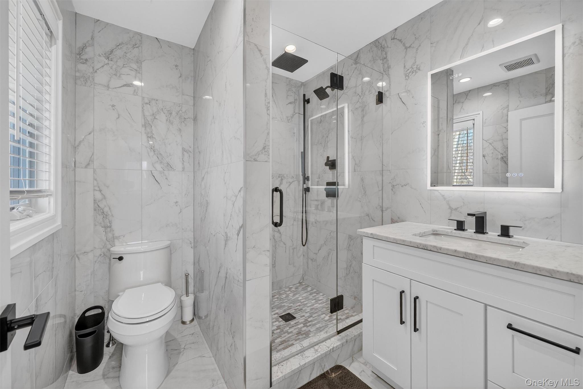 200 South Bedford Road Chappaqua, NY 10514 - Photo 22 of 38 a bathroom with a granite countertop sink a toilet and shower