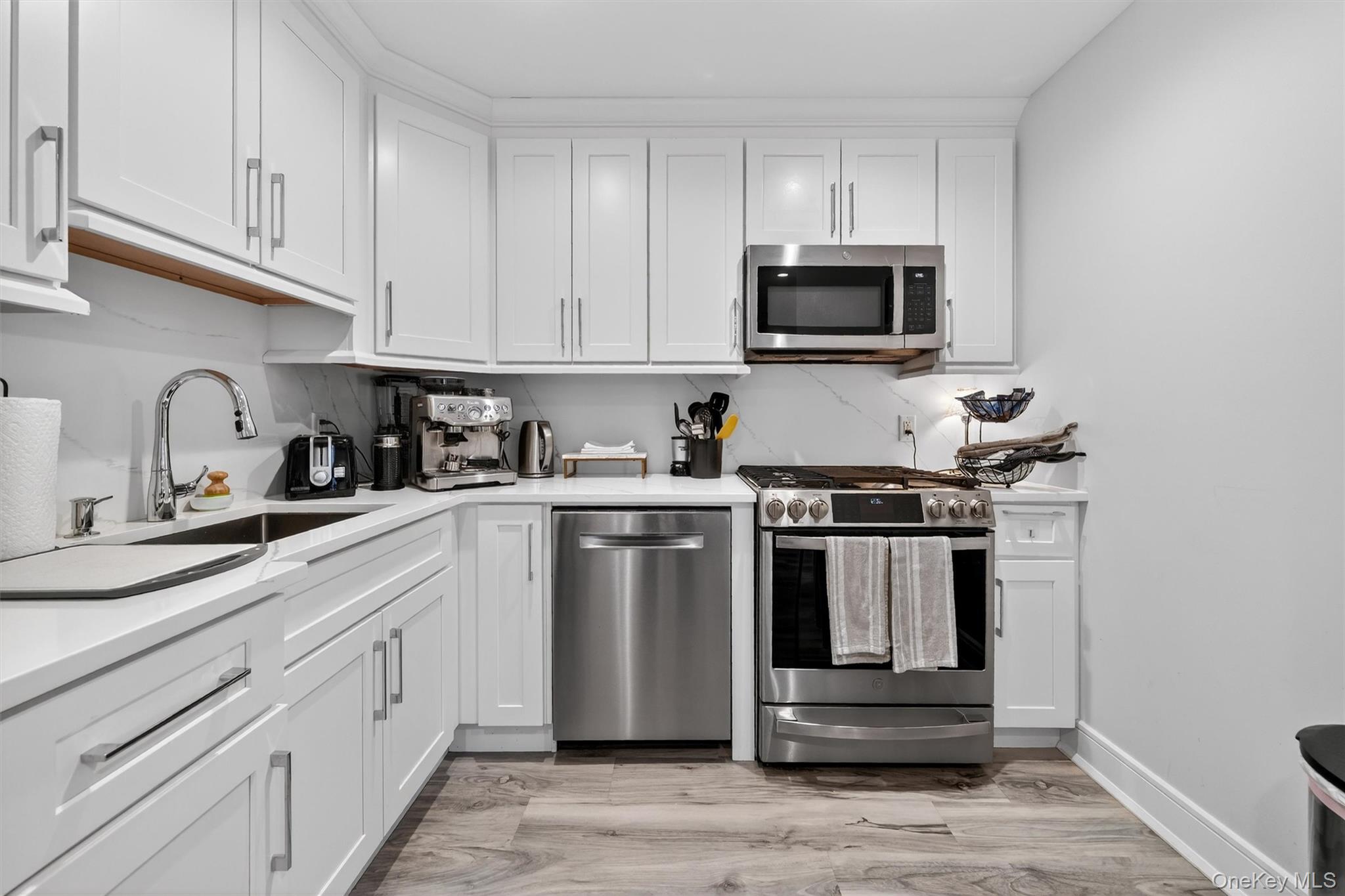200 South Bedford Road Chappaqua, NY 10514 - Photo 23 of 38 a kitchen with stainless steel appliances granite countertop a sink stove and microwave