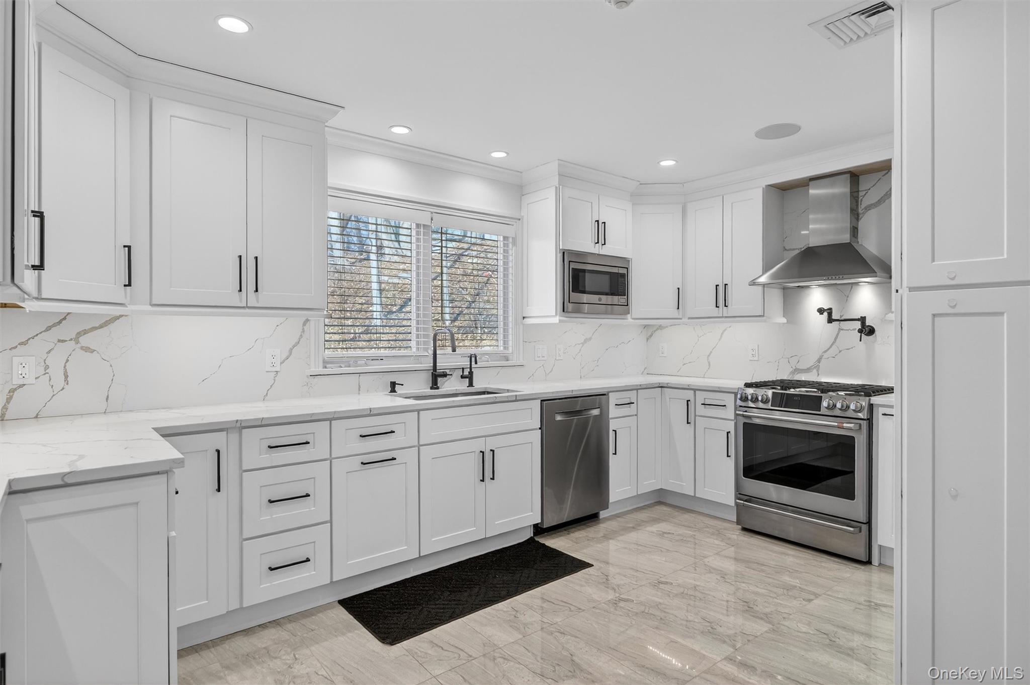 200 South Bedford Road Chappaqua, NY 10514 - Photo 6 of 38 a kitchen with granite countertop white cabinets and stainless steel appliances