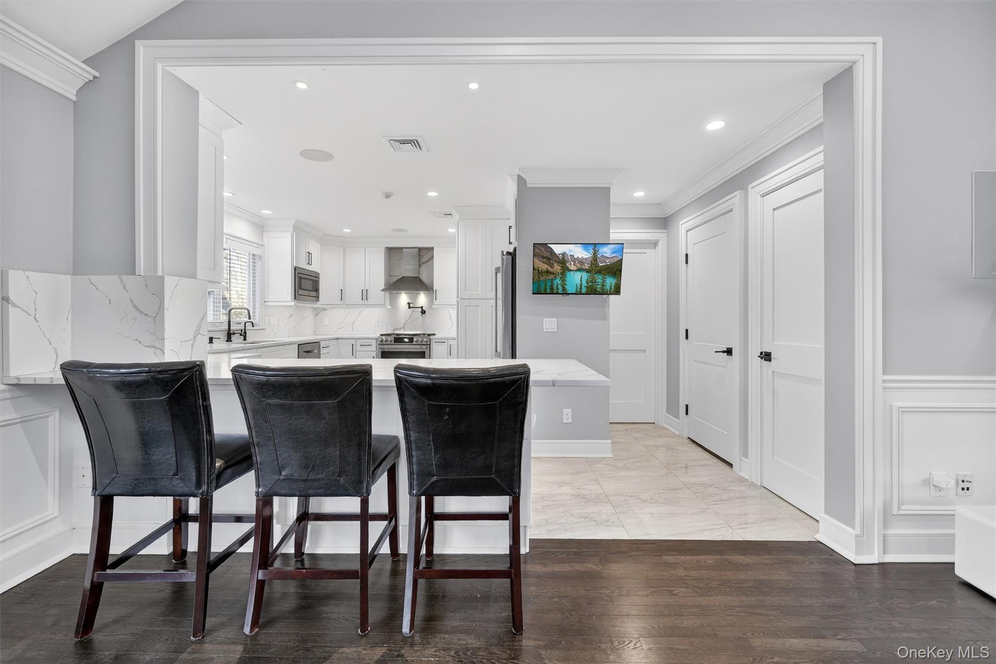 200 South Bedford Road Chappaqua, NY 10514 - Photo 9 of 38 a dining area with stainless steel appliances kitchen island granite countertop a table chairs and a refrigerator