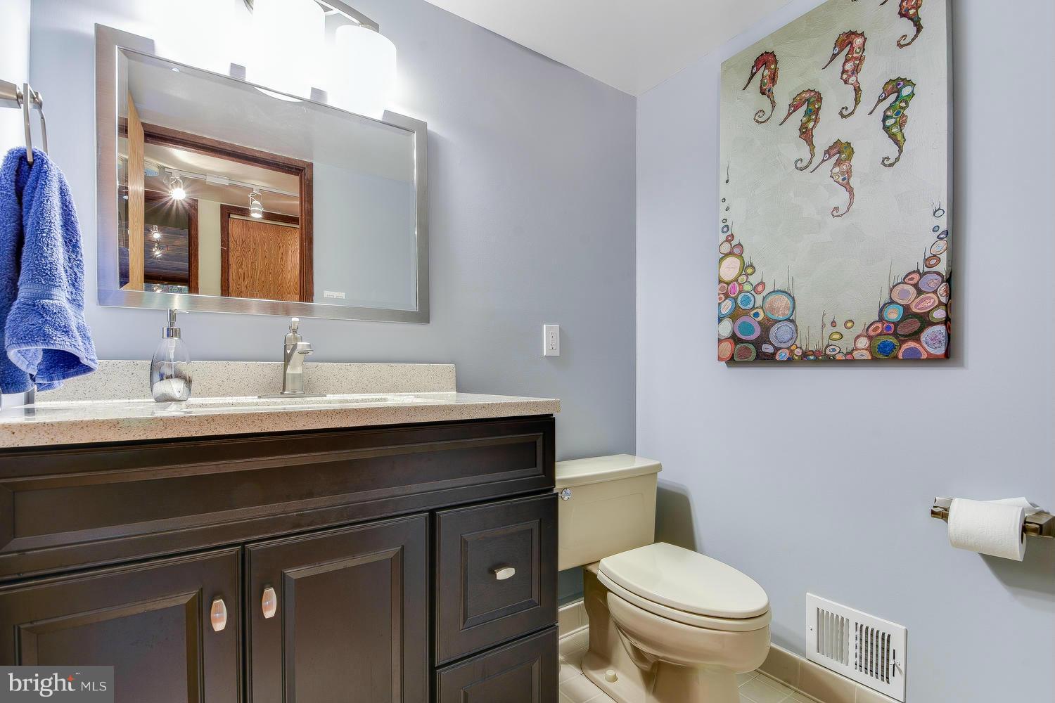 2004 Rebecca Court Silver Spring, MD 20906 - Photo 13 of 30 a bathroom with a toilet a sink and a mirror