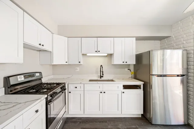 a kitchen with appliances a sink and a stove
