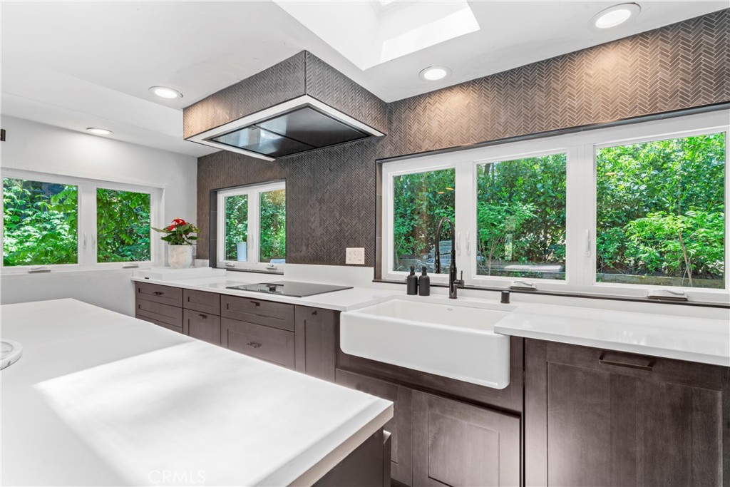 609 Millburn Road Lake Arrowhead, CA 92352 - Photo 14 of 60 a kitchen with a large window in it and kitchen island