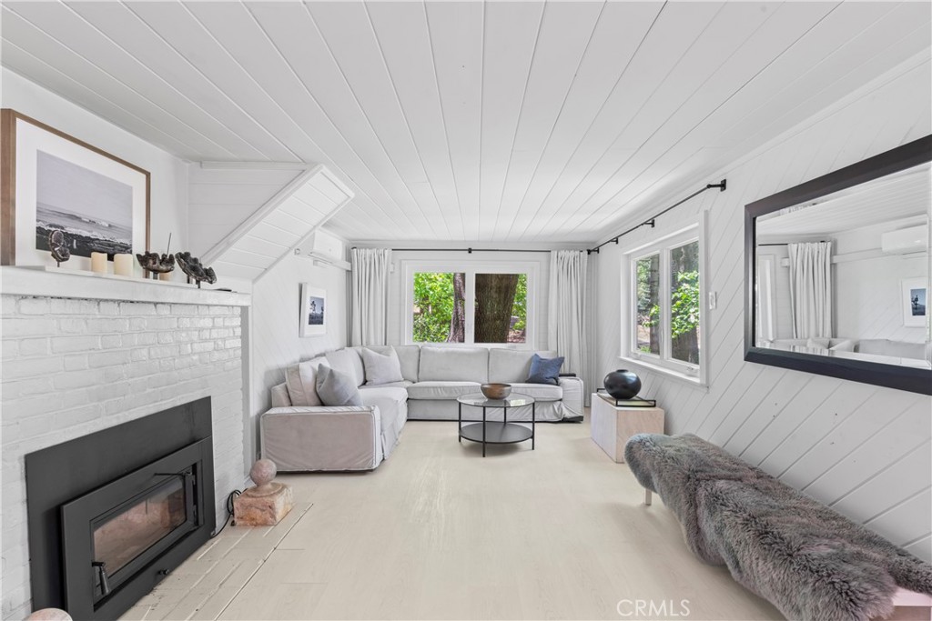 609 Millburn Road Lake Arrowhead, CA 92352 - Photo 17 of 60 a living room with furniture and a fireplace