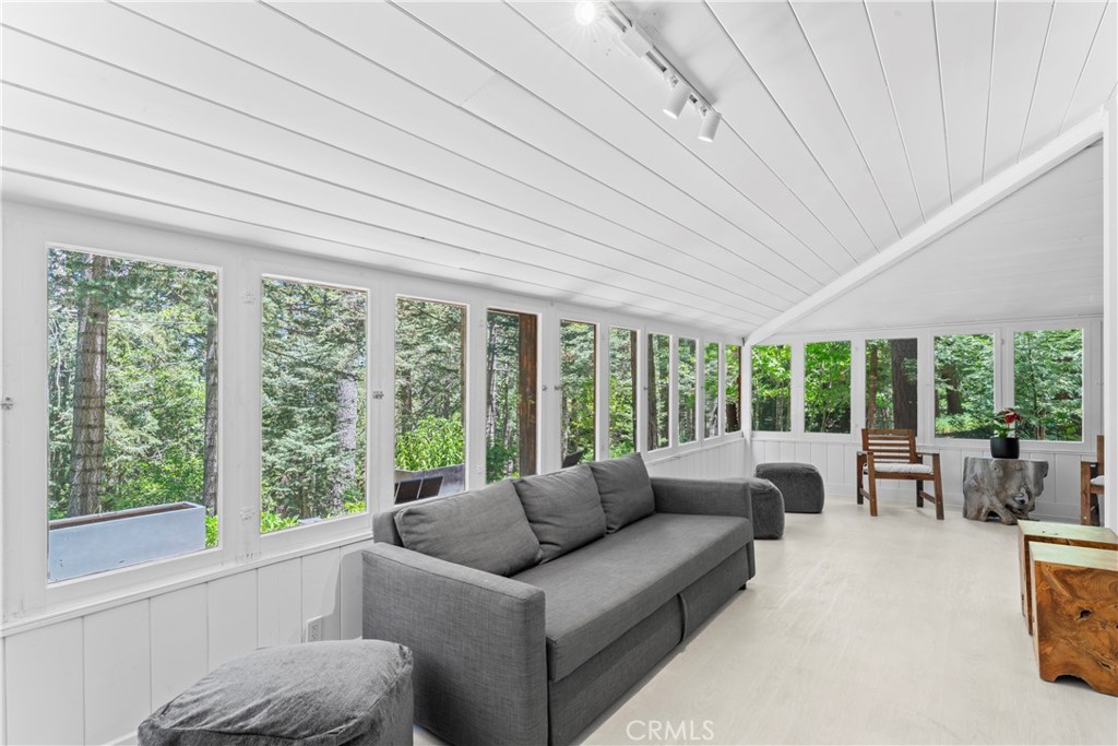 609 Millburn Road Lake Arrowhead, CA 92352 - Photo 22 of 60 a living room with furniture and a large window
