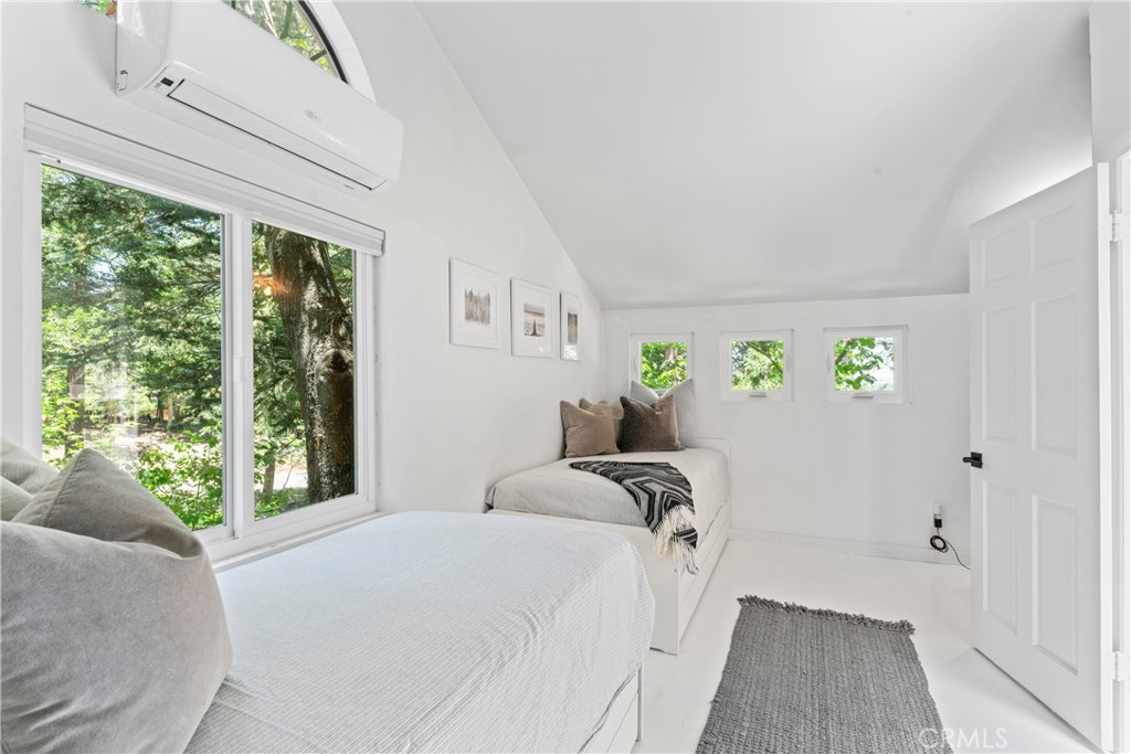 609 Millburn Road Lake Arrowhead, CA 92352 - Photo 36 of 60 a bed sitting in a bedroom next to a window