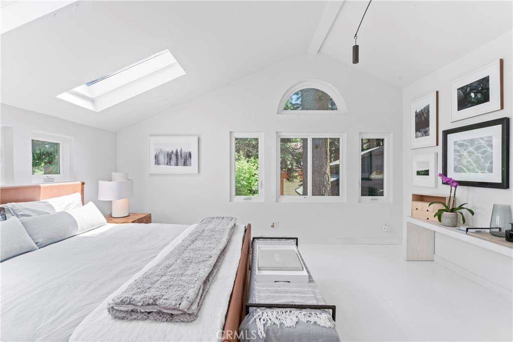 609 Millburn Road Lake Arrowhead, CA 92352 - Photo 41 of 60 a bed room with a bed a couch and a large window