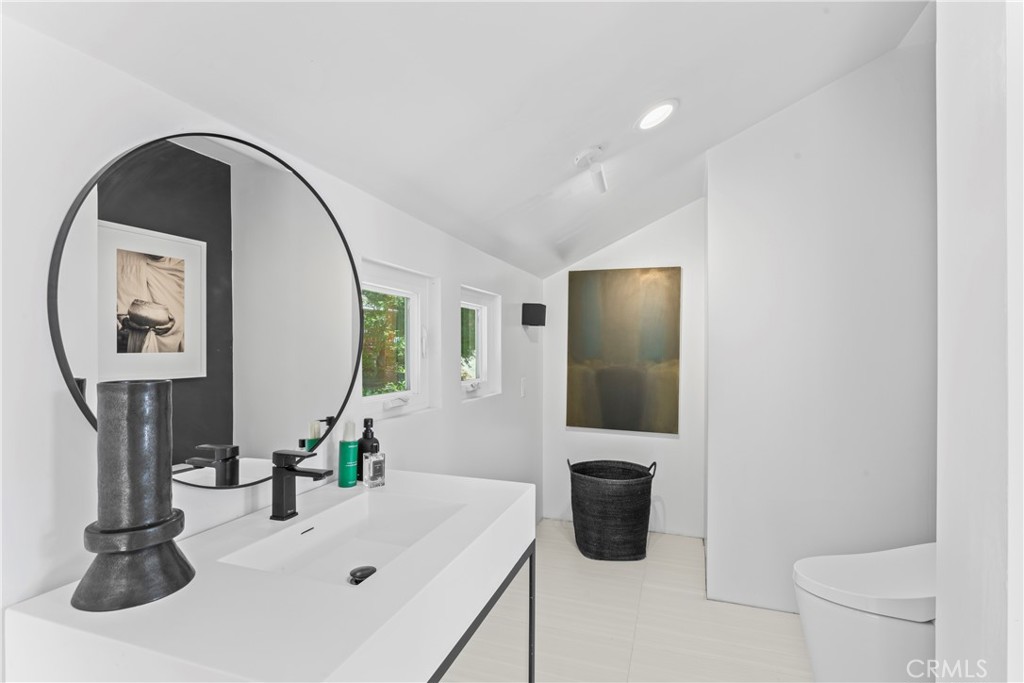 609 Millburn Road Lake Arrowhead, CA 92352 - Photo 46 of 60 a bathroom with a sink a toilet and a mirror