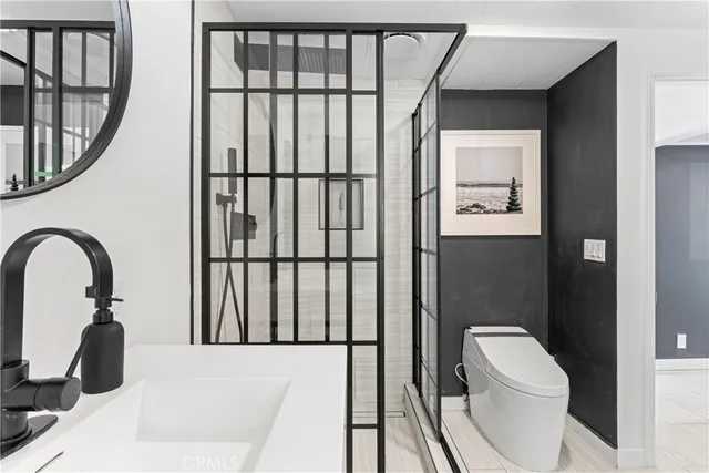 a bathroom with a toilet a sink and a window