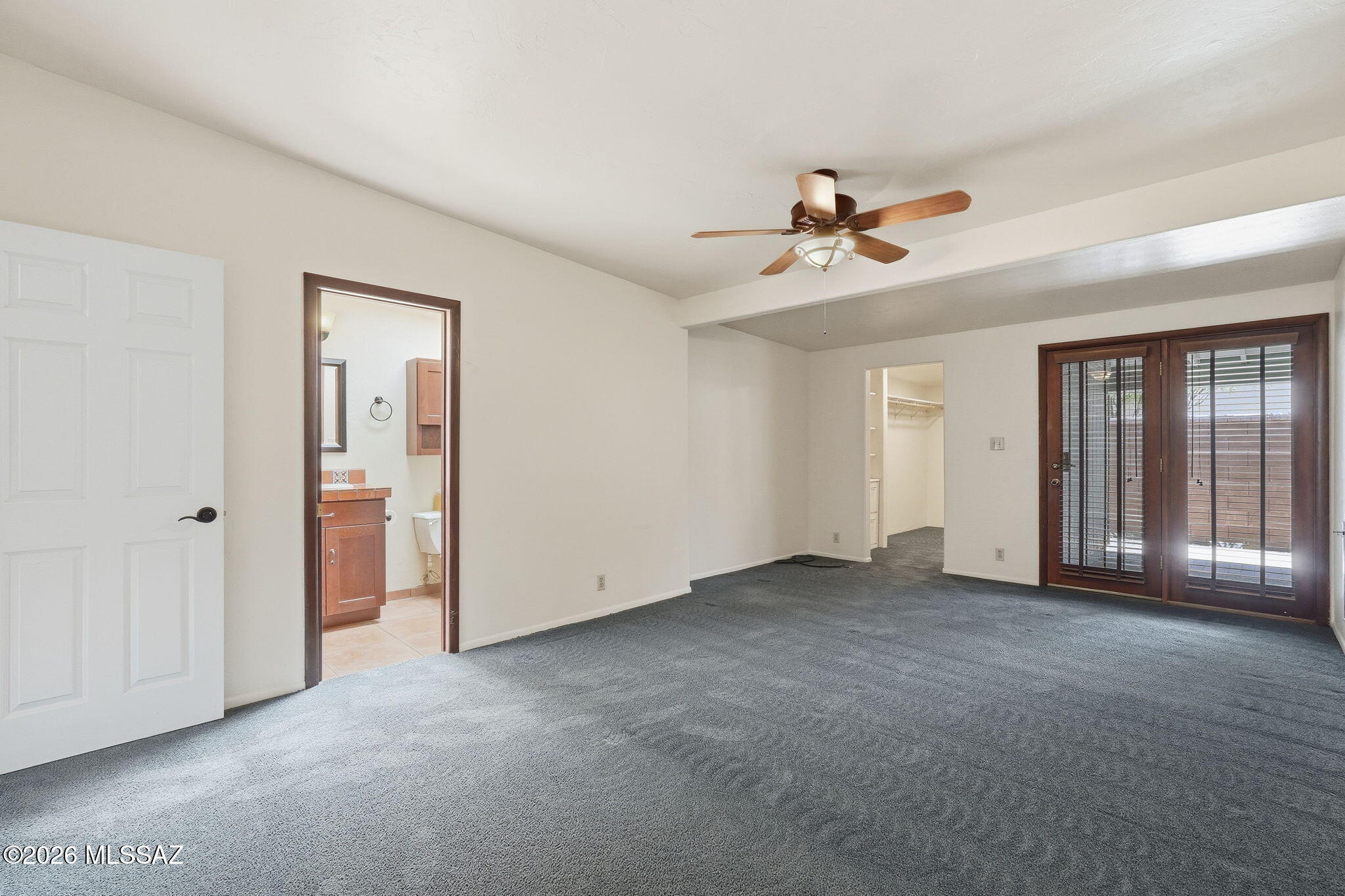 1125 East Kleindale Road Tucson, AZ 85719 - Photo 16 of 49 an empty room with chandelier fan and windows