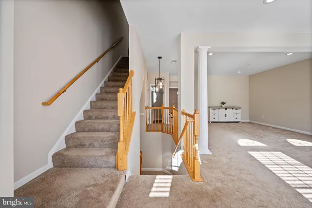 a spacious bedroom with a bed a couch and potted plant