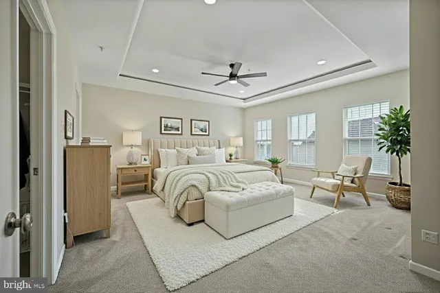 an empty room with windows and ceiling fan