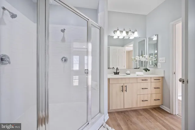 a bathroom with a granite countertop sink a toilet and a mirror