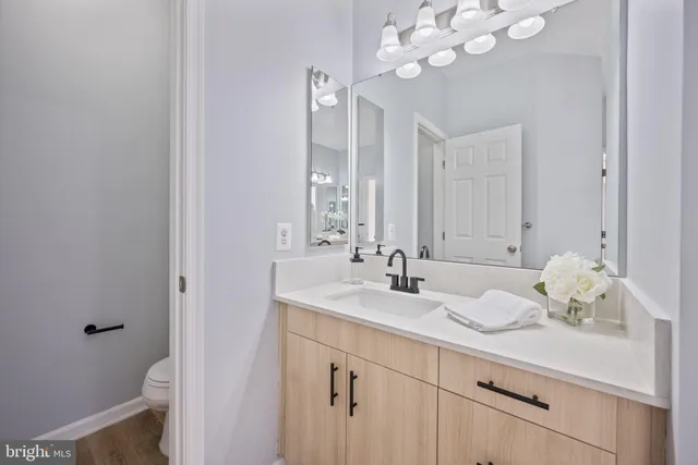 a white toilet sitting next to a white sink