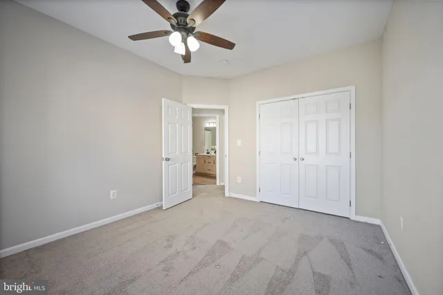 a bathroom with a double vanity sink mirror and toilet