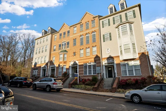 a view of a cars park in front of a building