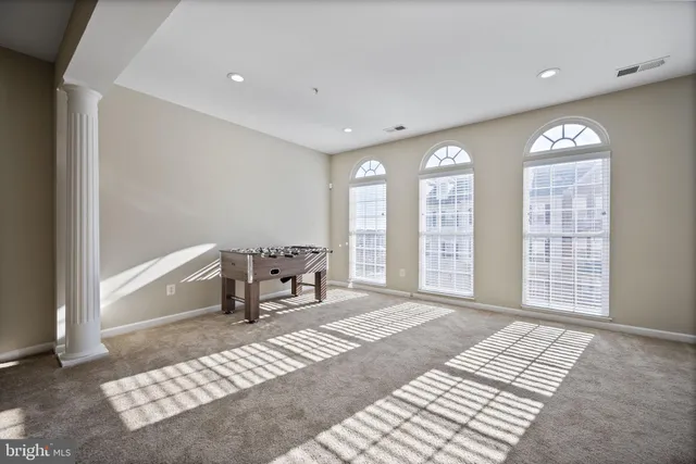 a spacious bedroom with a bed and a window