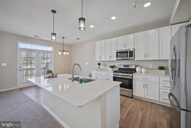 a view of a kitchen with microwave and cabinets