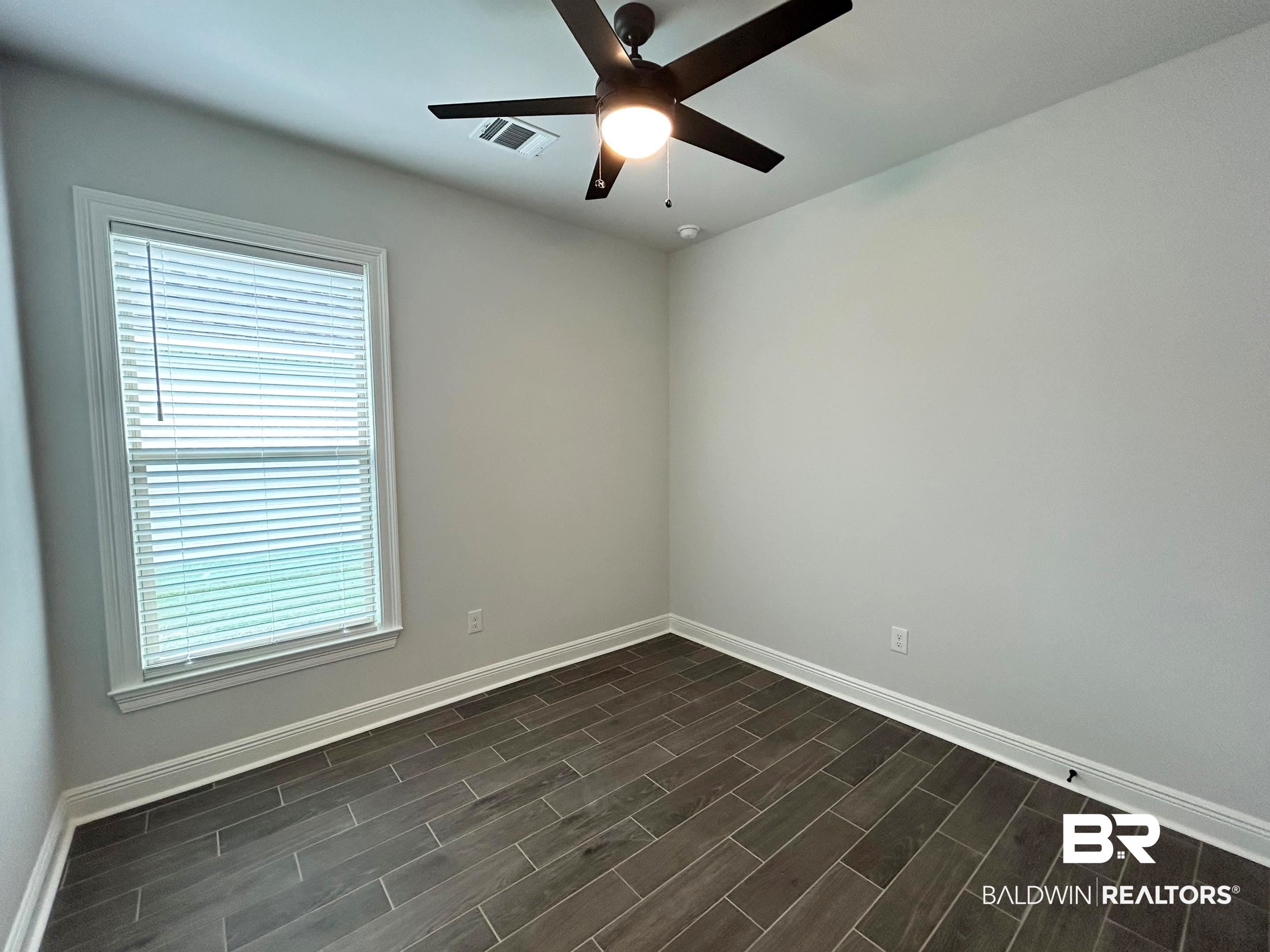 876 Sumter Loop Foley, AL 36535 - Photo 16 of 24 Empty room with ceiling fan and dark hardwood / wood-style floors